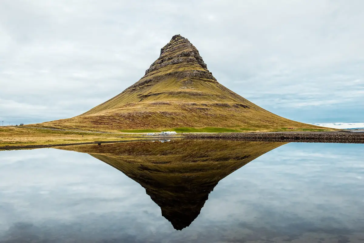 Kirkjufell mountain reflected in still water