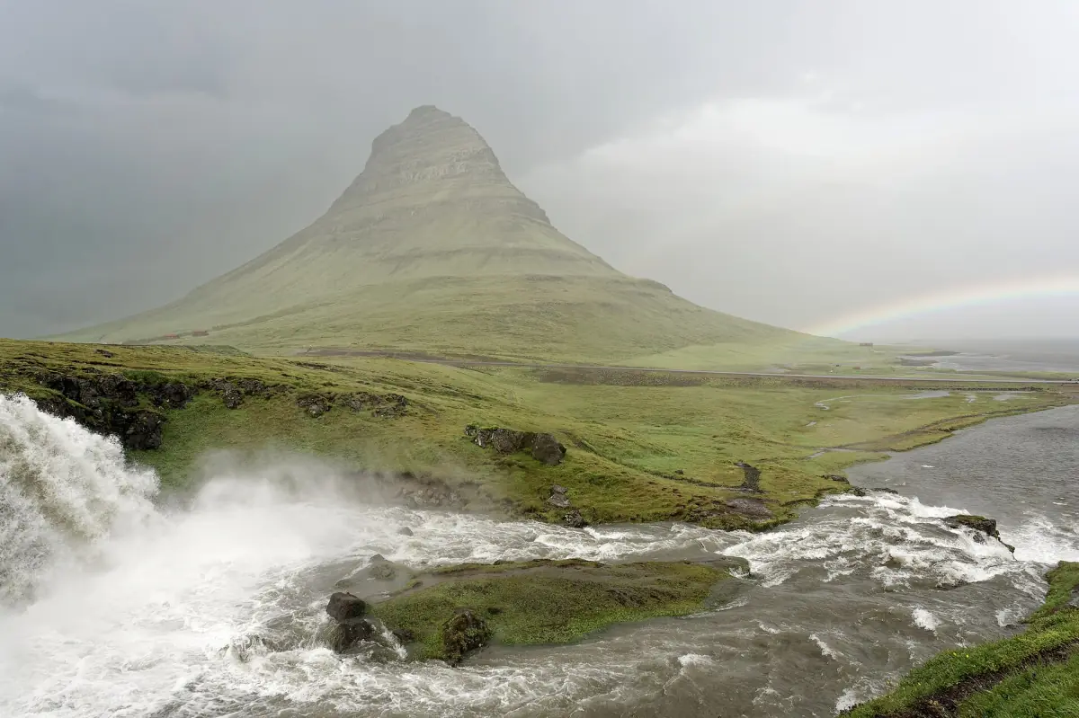 Kirkjufell above Kirkjufellsfoss with a rainbow